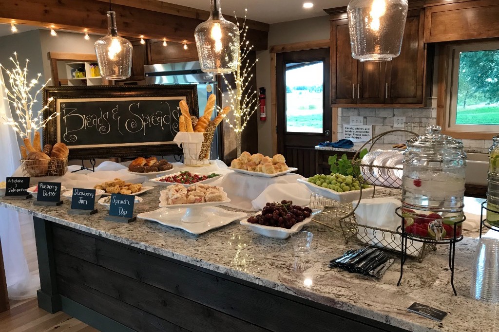 Sunday breakfast buffet on the lodge kitchen island — breads, spreads, fruit, and drinks