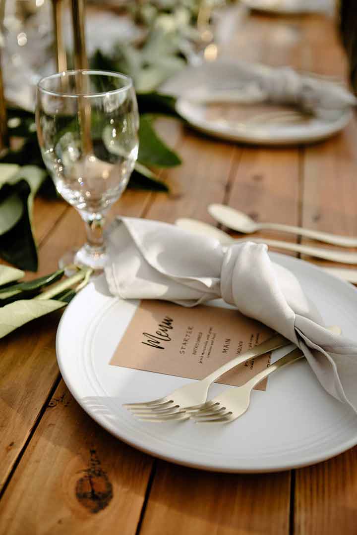 Place setting detail with gold flatware